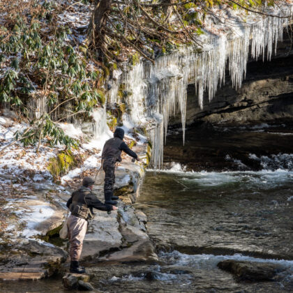 Two people fishing in winter